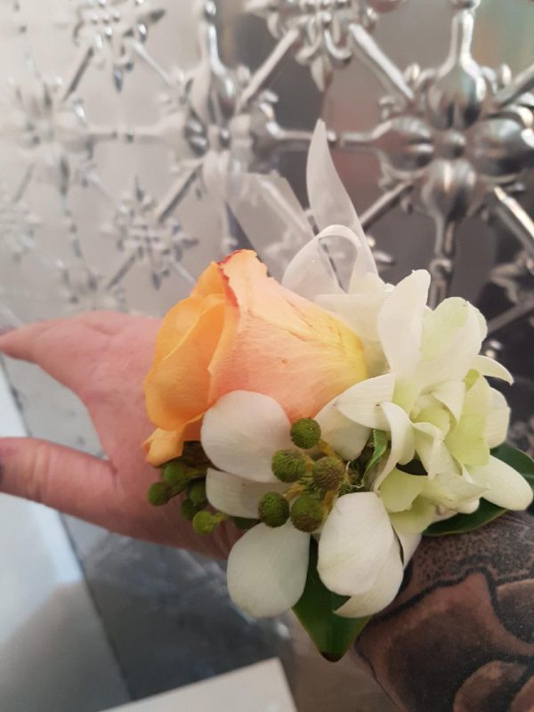 A White and peach corsage