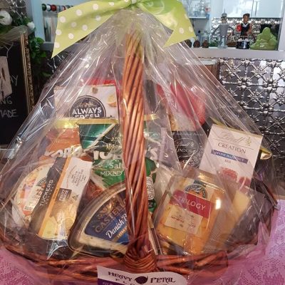 Hamper of snacks in basket, wrapped in cellophane