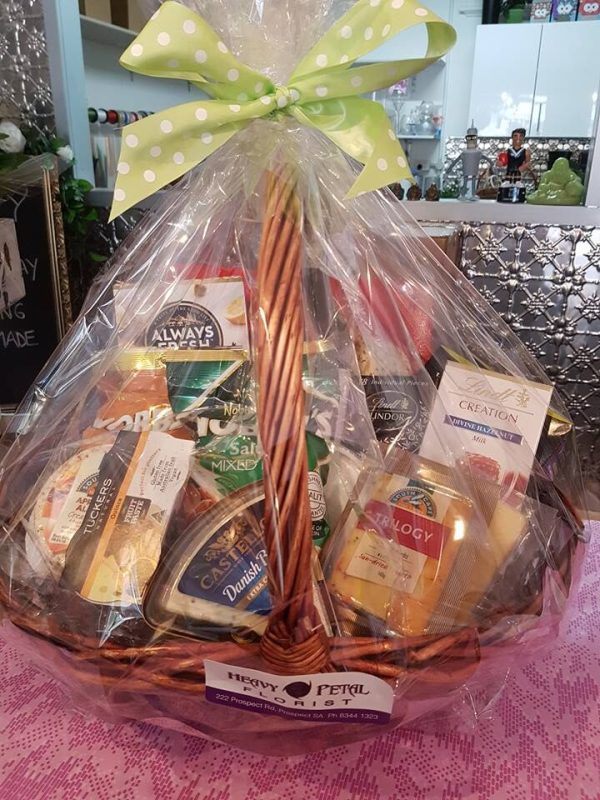 Hamper of snacks in basket, wrapped in cellophane