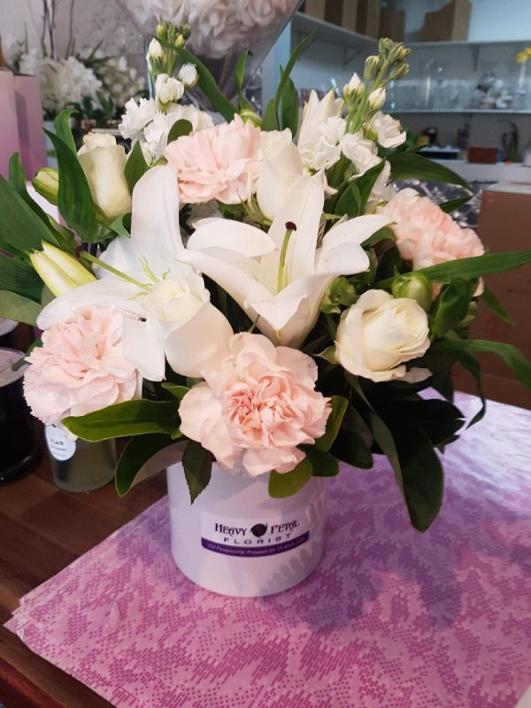 Arrangement of flowers in hat box