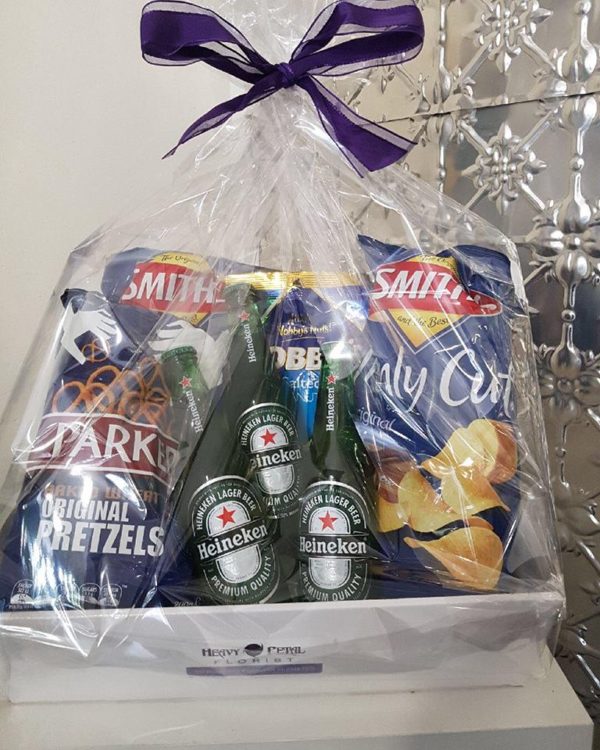 A hamper with beers, nuts, pretzels and chips.