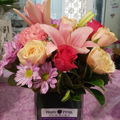 An arrangement of pink and orange flowers in a vase.