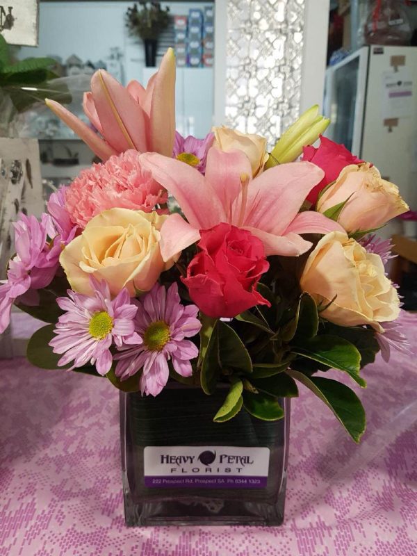 An arrangement of pink and orange flowers in a vase.