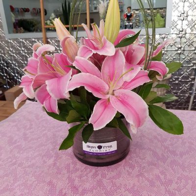 An arrangement of lillies in a vase.