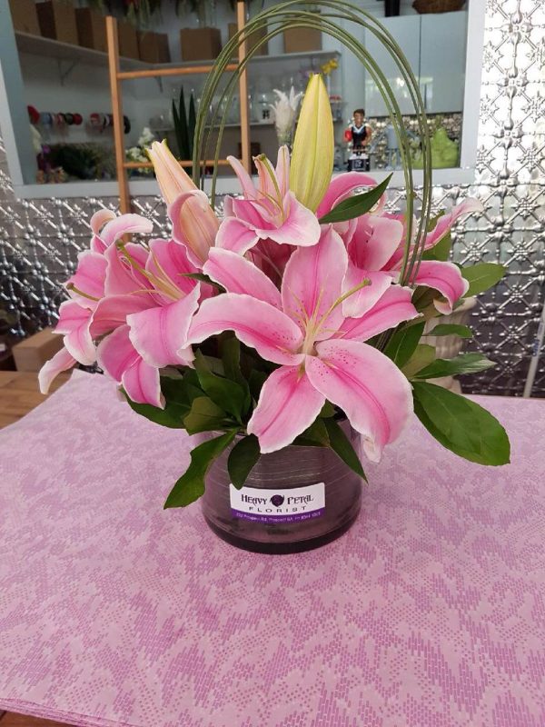 An arrangement of lillies in a vase.