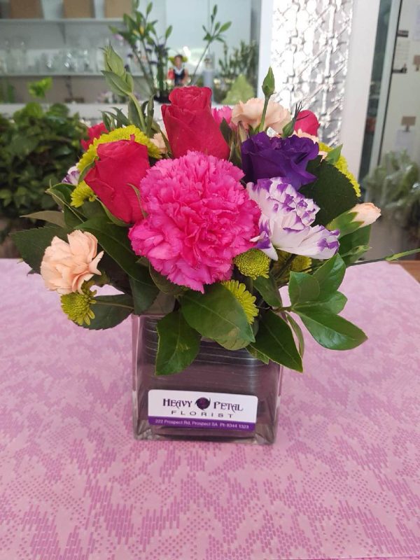 An arrangement of flowers in a glass vase.