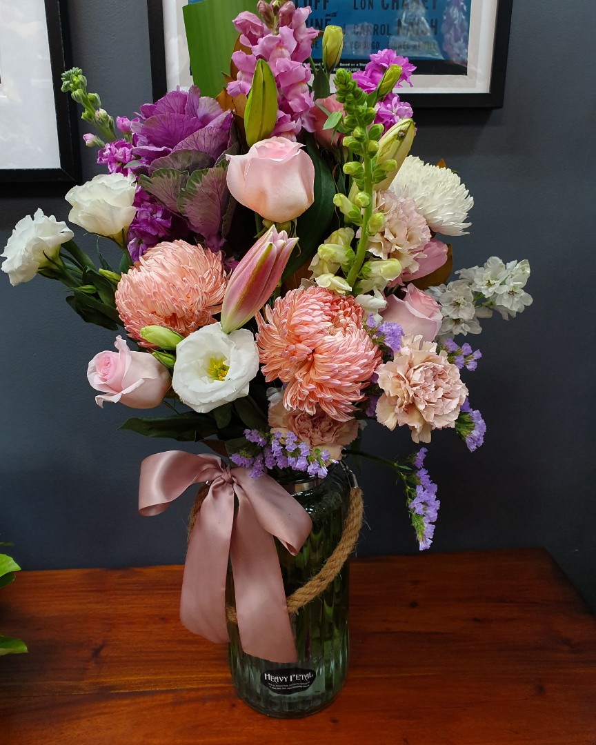A bouquet of flowers in a tall vase