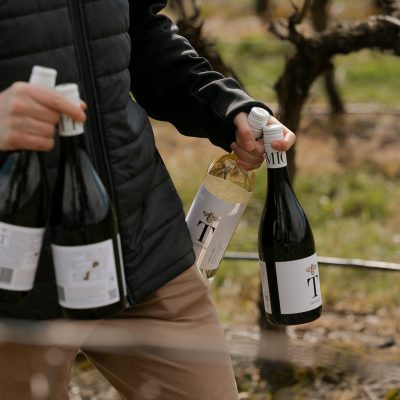 Person carrying bottles of Tomich wines
