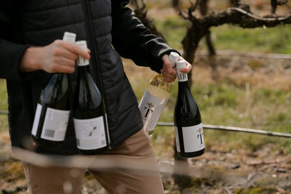 Person carrying bottles of Tomich wines