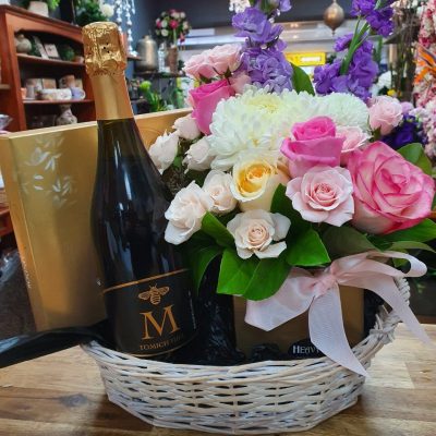 A Floral hamper basket with wine and chocolates