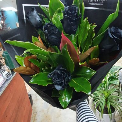 Bouquet of roses, dyed black, wrapped in paper