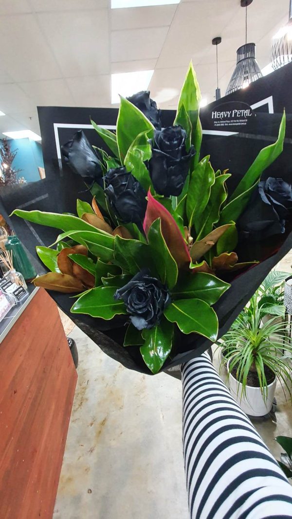 Bouquet of roses, dyed black, wrapped in paper